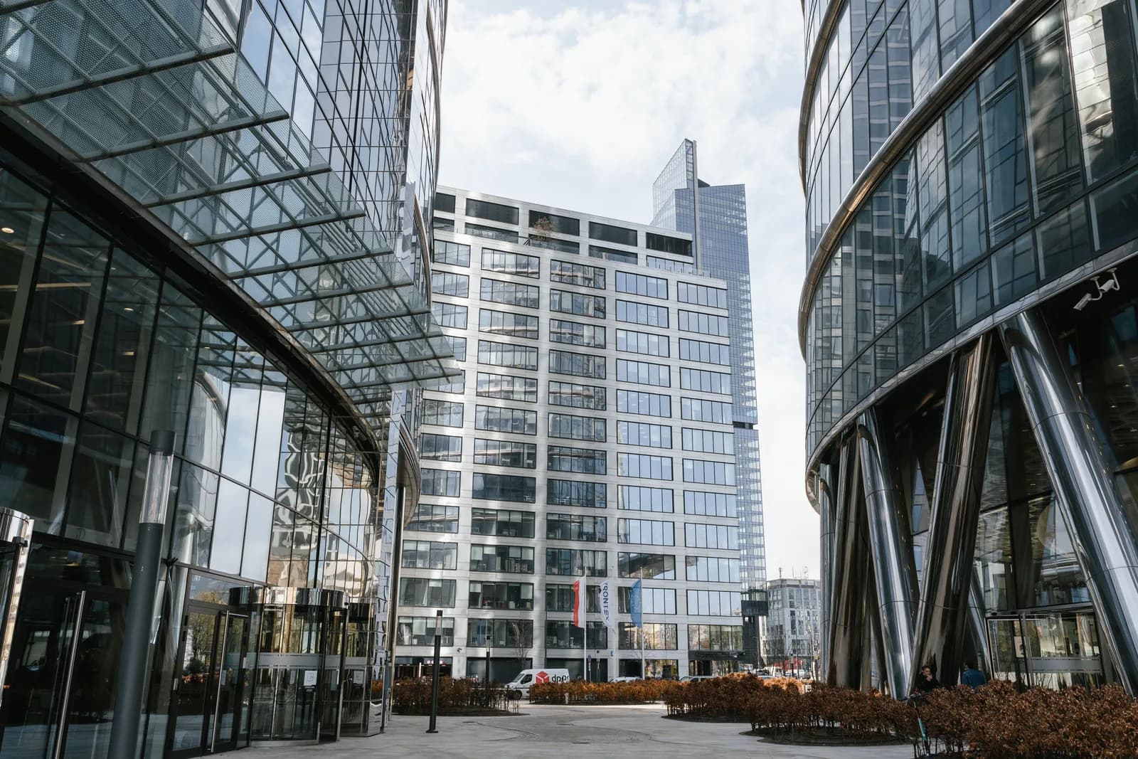 Glass-fronted commercial office buildings around an urban courtyard